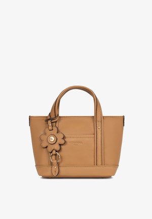 Tan leather handbag with double handles, a front pocket, and a flower-shaped leather keychain detail.