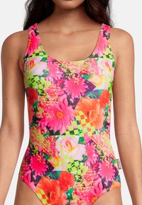 Maillot de bain une pièce avec des motifs floraux et géométriques vibrants, mettant en avant des couleurs rose néon, jaune et vert. Fabriqué à partir d'un tissu extensible et lisse.