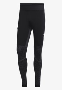 Black athletic leggings feature a high waist, seamless design, textured black panels, and side pockets for practicality.
