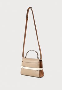 Small beige leather handbag with a detachable brown shoulder strap, features a structured shape and a white accent band across the front.