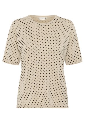 T-shirt beige à manches courtes avec un col rond et un motif à pois noir sur toute sa surface. Texture lisse avec une silhouette ajustée.