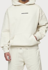 Pegador Jersey con capucha - beige