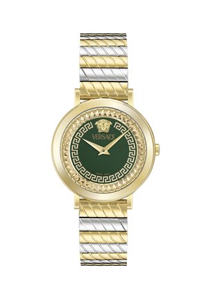 Gold and silver-tone watch featuring a green dial, embossed lion logo, geometric pattern bezel, and a twisted link bracelet design.