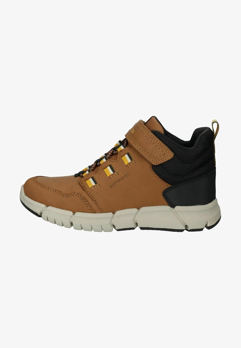 Brown leather shoe with black fabric accents, thick sole, and a Velcro strap. Features yellow and white patterned detailing on the laces.