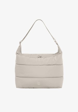 Beige puffer tas met een dikke, gewatteerde textuur, vlakke bodem en een enkele schouderriem. Voorzien van een ritssluiting en logo aan de voorkant.