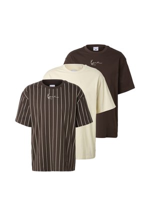 Three short-sleeve crew neck t-shirts in cream, solid dark brown, and dark brown with white vertical stripes, each with a small white signature print.