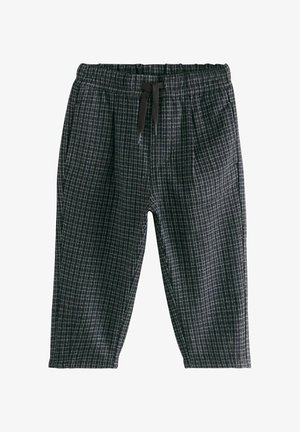 Pantaloni în carouri alb-negru cu talie elastică și șnur negru, proiectați pentru o potrivire lejeră.