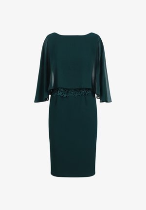 Knee-length Kleid aus tiefgrünem Stoff mit einem transparenten Überwurf, ausgestattet mit einer Spitzenakzentuierten Taille. Glatte Textur und taillierte Silhouette.