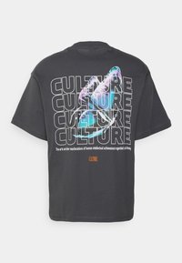 Black cotton t-shirt featuring a colorful graphic of a hand with text "CULTURE" repeated. Includes orange "CLTRE" logo. Short sleeves, relaxed fit.