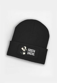 Black knitted beanie featuring a stitched patch with a cartoon badger and the text "FRECH DACHS." Soft texture and snug fit.
