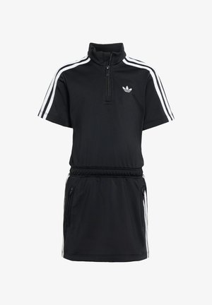 Svart atletisk kjole med korte ermer, halvlange glidelåskrage, hvite sidestriper og elastisk midjebånd. Har glidelåslommer på sidene.