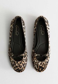Leopard print ballet flats with a rounded toe, black trim, small bow detail, and a cushioned interior for comfort.