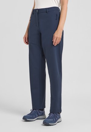 Navyblauwe outdoorbroek, gemaakt van zacht, waterdicht materiaal. Bevat ritszakken, een gestroomlijnd ontwerp en subtiele stikseldetails.