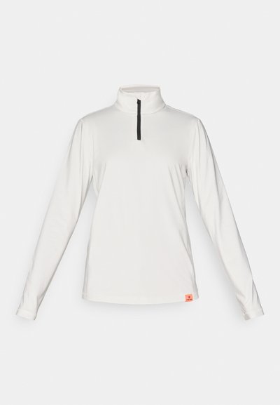 Λευκή μπλούζα επιδόσεων με μακριά μανίκια, υψηλό γιακά και φερμουάρ έως το ¼. Διαθέτει μαύρο φερμουάρ και μικρή πορτοκαλί ετικέτα της μάρκας στο στρίφωμα.