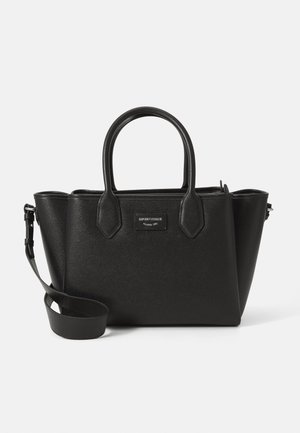 Black leather handbag with double handles, detachable shoulder strap, and a small rectangular brand label on the front.