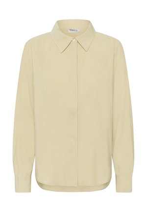 Kreemjas pikkade varrukatega nööpidega särk terava kraega, esikülje peidetud nööpide ja kergelt ümarate servadega.