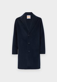 Manteau long en mélange de laine bleu marine avec un col cranté, une fermeture à boutons sur le devant et deux poches latérales. Texture lisse et coupe mi-longue.