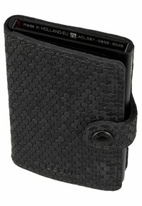 Black wallet with hexagonal textured leather exterior, metal accents, and a button closure. Features a slim, minimalist design.