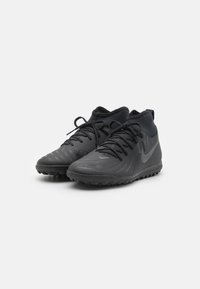 Black athletic shoes with textured synthetic upper, lace-up design, low ankle fit, and rubber outsole for traction. Silver logo on side.