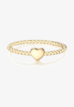 Brazalete de metal retorcido en tono dorado con un charm en forma de corazón liso en el centro. Presenta un acabado brillante y una forma redonda uniforme.