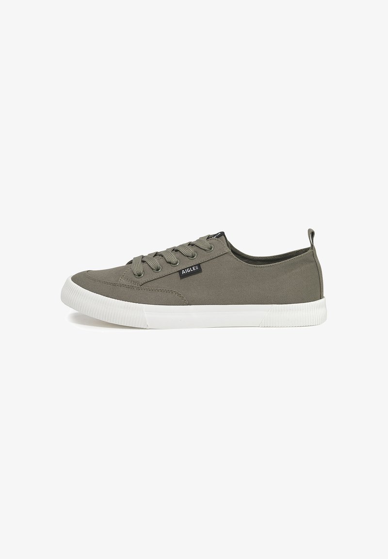Green canvas sneakers with white rubber sole, round toe, and lace-up design. Features a small black logo tag on the outer side.