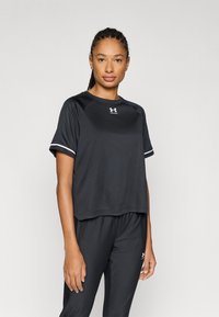 Black athletic shirt with short sleeves, a round neckline, and white accents on the sleeves. Made from a smooth, moisture-wicking material.