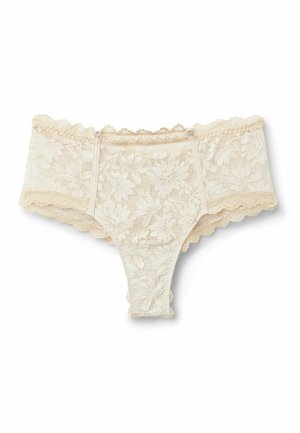 String femme en dentelle couleur crème avec motifs floraux et bords festonnés, avec petites bretelles latérales réglables.