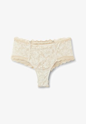 Damen-String in Cremefarbe aus Spitze mit floralen Mustern und gezackten Kanten, mit kleinen verstellbaren Seitenträgern.