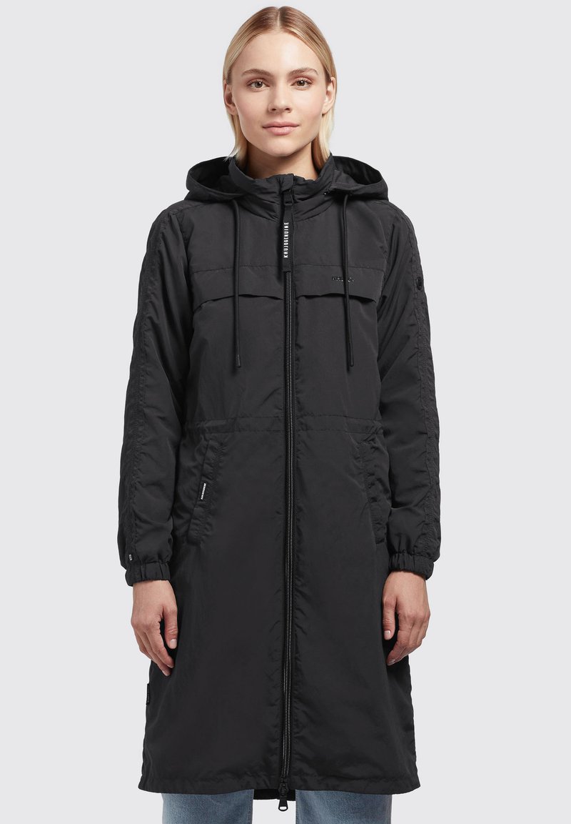 Black parka with a zip closure, hood, two chest pockets, elastic cuffs, and a relaxed fit. Made from lightweight, quilted material.