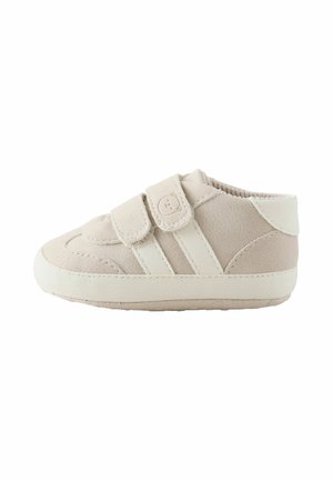 Soft beige toddler shoe with two velcro straps and white sole, side view on a white background.