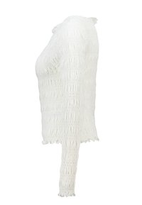 White long-sleeve top with a smocked texture, featuring a fitted design and ruffled edges at the neckline and cuffs.