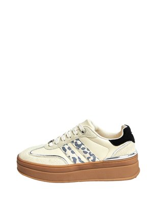 Cream and beige platform sneaker with white laces, leopard-patterned side stripes, black heel tab, and thick brown sole.
