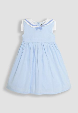 Šviesiai mėlyna suknelė su balta apykakle ir kaspinu. Vertikalių juostelių tekstūra, trumpi rankoviai ir susiraukšlėta sijono konstrukcija. Uždarymas mygtuku nugaros pusėje.