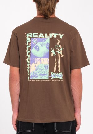 Brown cotton graphic t-shirt featuring bold text, multicolored images, and a relaxed fit. Design includes visual elements like stars and faces.