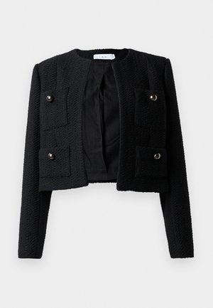 Veste noire courte en tissu texturé, avec un col rond, deux poches avant avec fermeture pression, et une conception ouverte à l'avant.