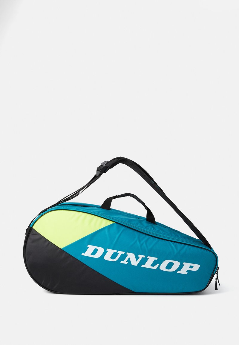 Dunlop-Tennistasche mit einer schlanken ovalen Form. Hergestellt aus türkisfarbenem, schwarzem und fluoreszierend grünem Material, verfügt über einen oberen Griff und einen Schultergurt.