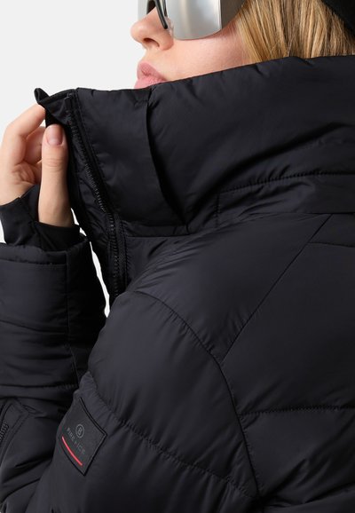 Black puffer jacket with a high collar and zip closure. Features include quilted texture, a logo patch on the sleeve, and smooth fabric.