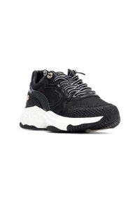 Zapatilla negra con un upper texturizado, media suela blanca y acentos estampados. Presenta un diseño con cordones y un prominente relieve en la suela.