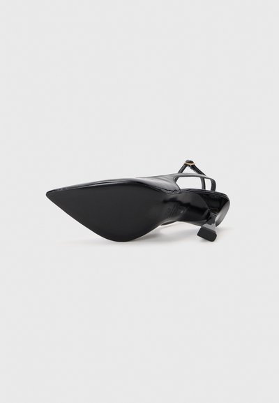 Black high-heeled shoe with a pointed toe and a smooth patent finish. Features a thin ankle strap and a block heel for stability.