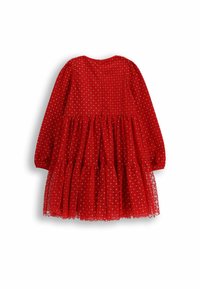 Czerwona sukienka z długimi rękawami, warstwową spódnicą i wzorem w groszki. Posiada okrągły dekolt i zapięcie z tyłu.