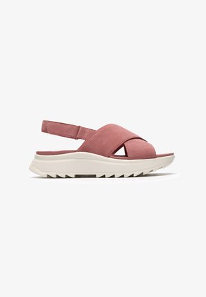 Sandalo color rosa con design a incrocio, tomaia sintetica e suola bianca imbottita con motivo antiscivolo texture.