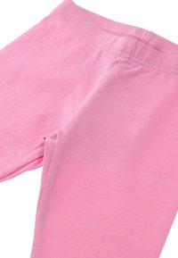 Ljust rosa bomullsleggings med en åtsittande design, slät textur och en elastisk midja, med platta sömmar för komfort.