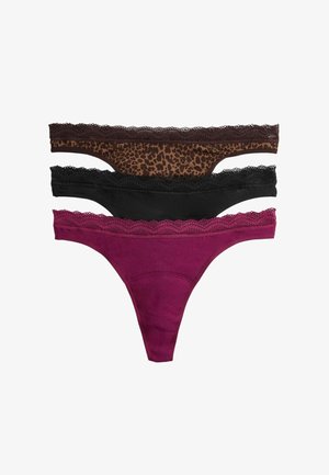 Trois strings pour femmes bordés de dentelle, imprimé léopard, noir uni et rose foncé uni, empilés sur un fond blanc.