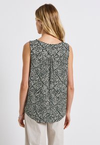 Ärmelloses Oberteil mit einem grünen und cremefarbenen Zebra-Print. Der Rücken verfügt über eine mittlere Falte, einen abgerundeten Saum und einen weichen, strukturierten Stoff.