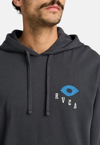 Gray cotton hoodie featuring a blue eye graphic and "RVCA" in white embroidery. Includes a front kangaroo pocket and adjustable drawstring hood.