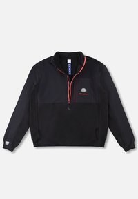 Veste à enfiler noire avec fermeture éclair rouge, poche poitrine ornée d'un logo de cerveau blanc et du texte « Rhude Project », et manches longues, sur fond uni.