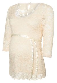 Lace maternity top in cream with long sleeves, scalloped hem, and satin ribbon tie at the waist, featuring floral patterns throughout.