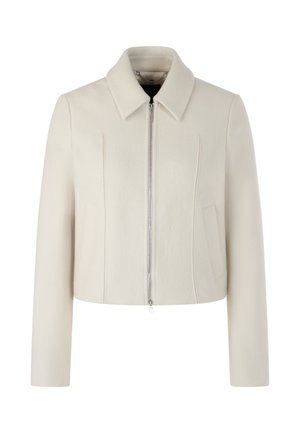 Cropped cream jacket in soft, textured fabric. Features a straight collar, front zip closure, and two side pockets with stitched details.
