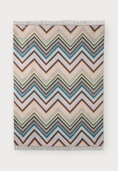 Patterned throw blanket featuring chevron stripes in shades of blue, brown, green, and orange, finished with fringed edges.