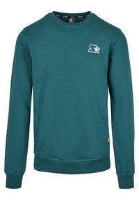 Sweatshirt à col rond bleu sarcelle avec manches longues, poignets et ourlet côtelés, petite étoile blanche sur la poitrine gauche et étiquette près de la taille.